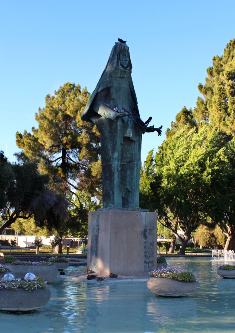 The Saint Clare statue in the fountain at the Santa Clara Civic Center at dusk