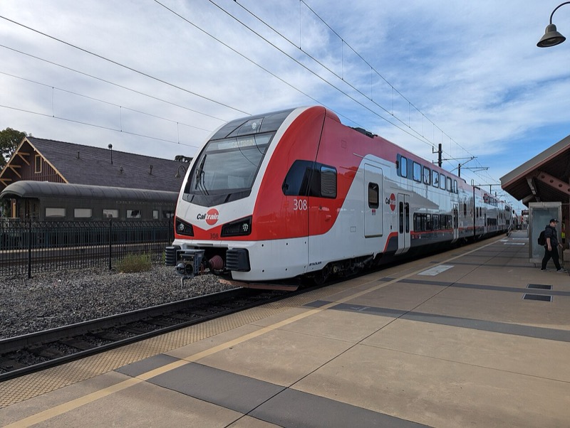 An electric Caltrain at the Santa Clara station beside the historic depot